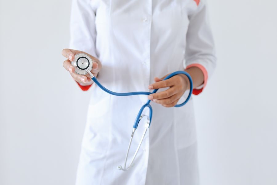 A healthcare professional holding a stethoscope